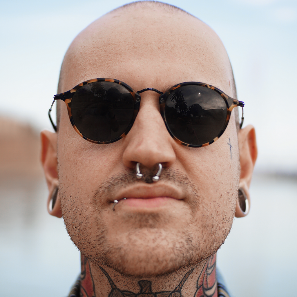 A man with a labret and septum piercing.