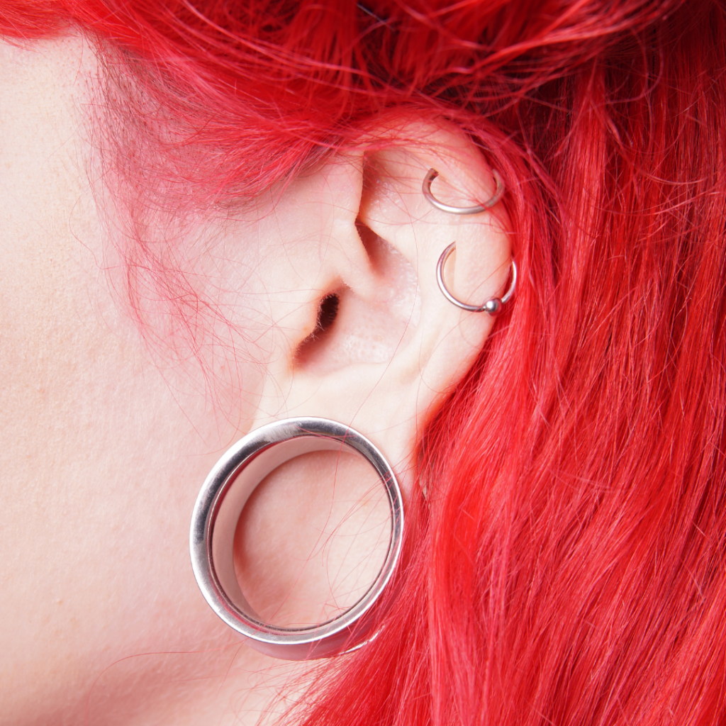 Side view of an ear with piercings.