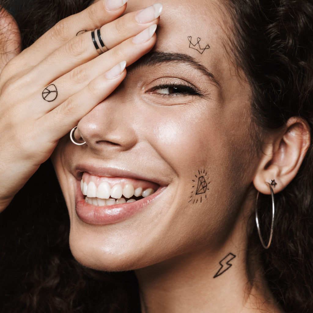 Woman with nose piercing and tattoos.