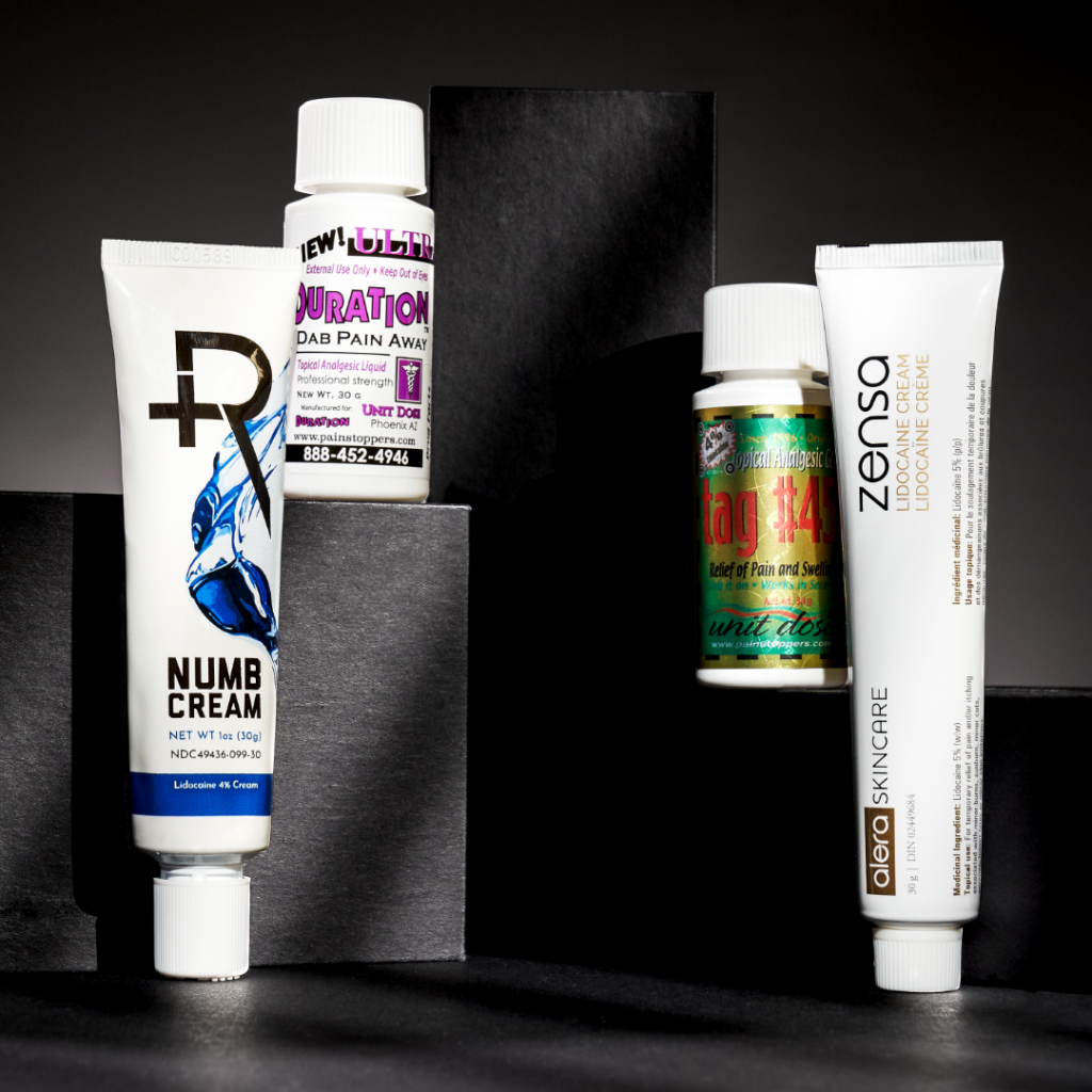 An assortment of numbing creams, including Recovery Numb Cream.