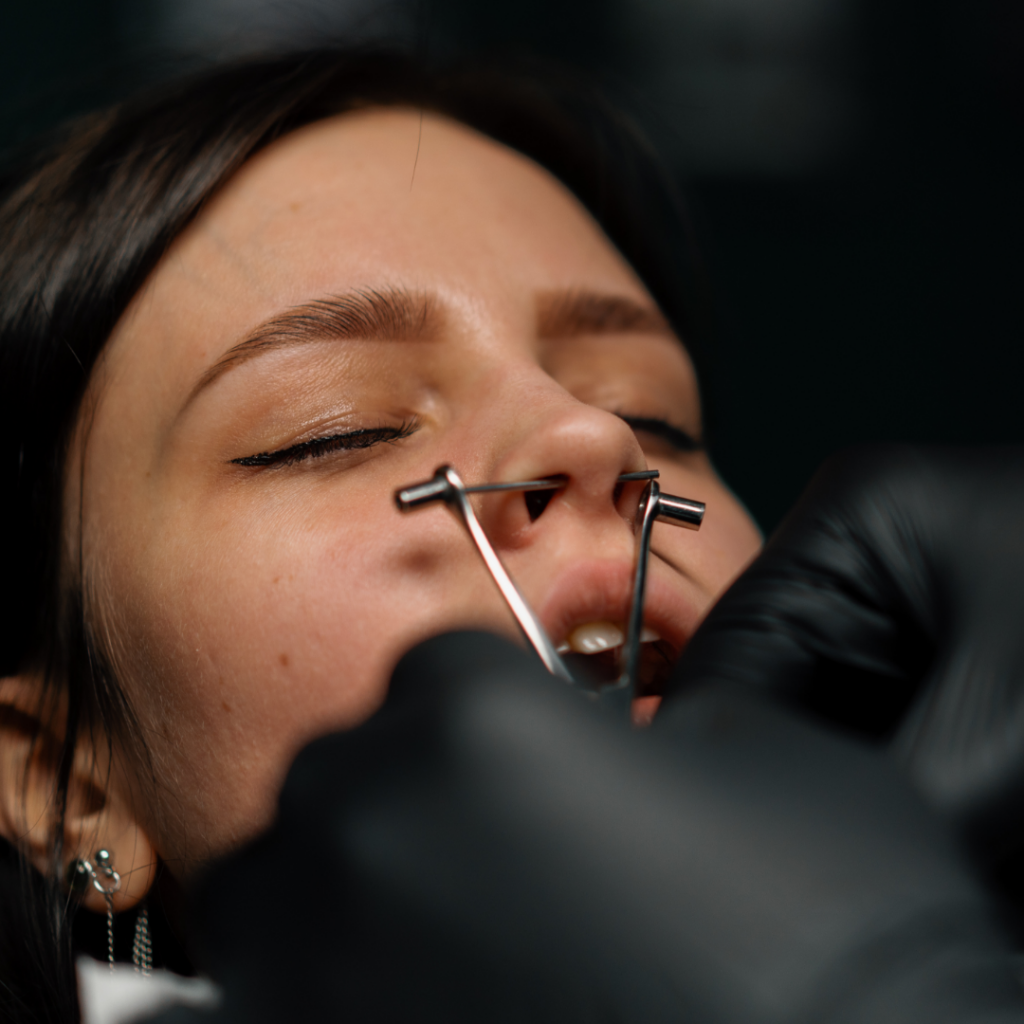 A septum piercing is underway.
