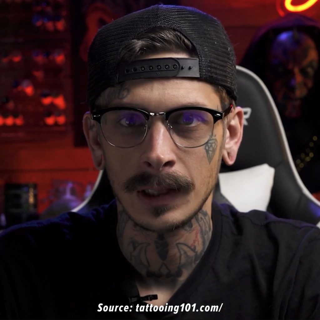 Tattoo artist facing the camera.